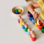 kid-plays-with-educational-toy-that-helps-learn-colors-kindergarten-table_383647-873